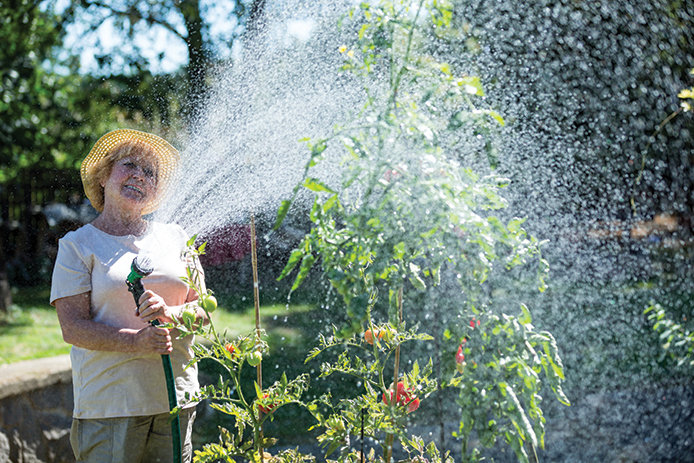 694x463-womanwateringgardenhose.jpg?Revision=wSj1&Timestamp=S9rZFx